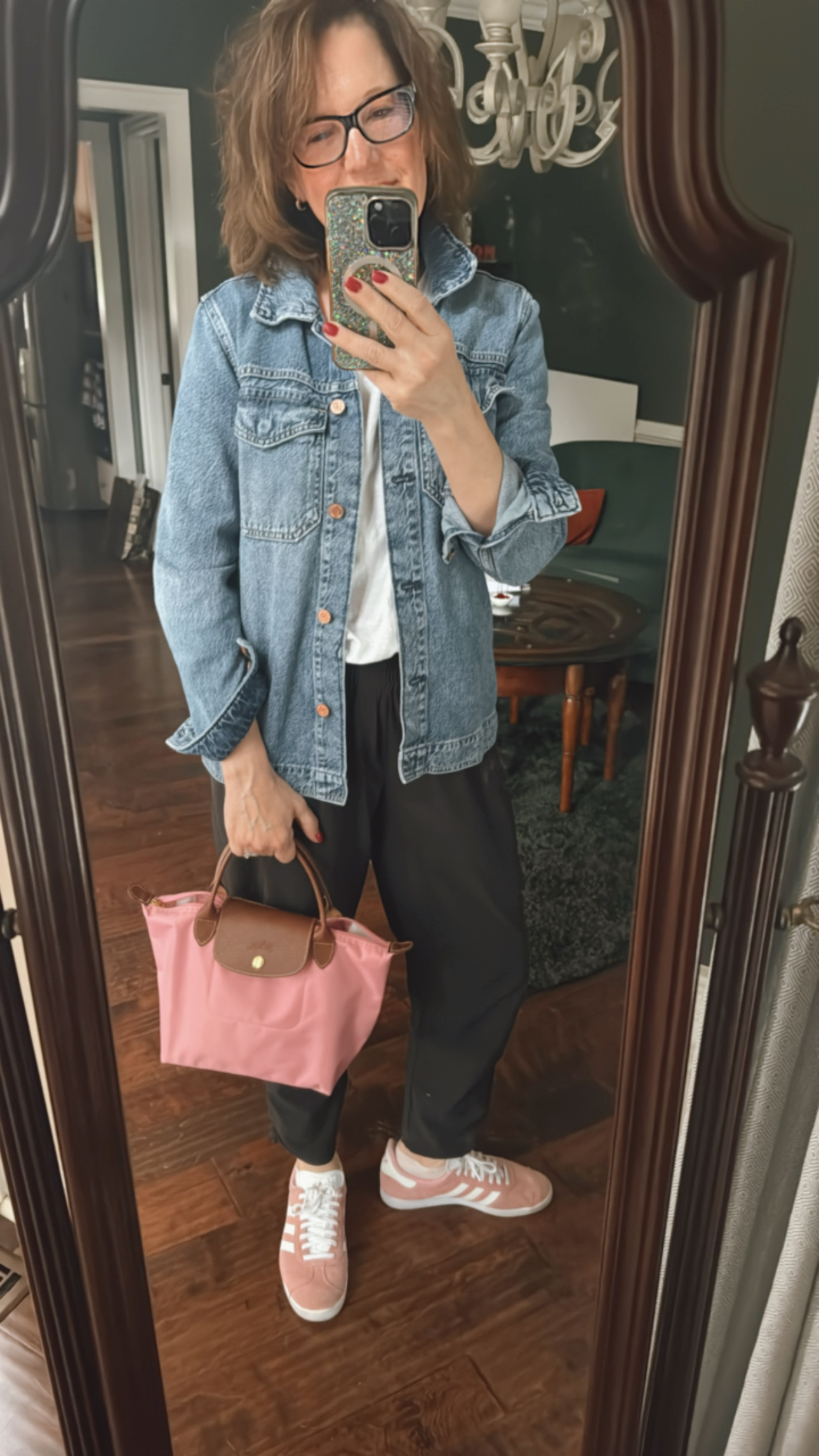 Jenn Clements wearing a casual styled outfit—joggers, tee, denim jacket, and pink sneakers—demonstrating how getting dressed is self-care for women over 40.